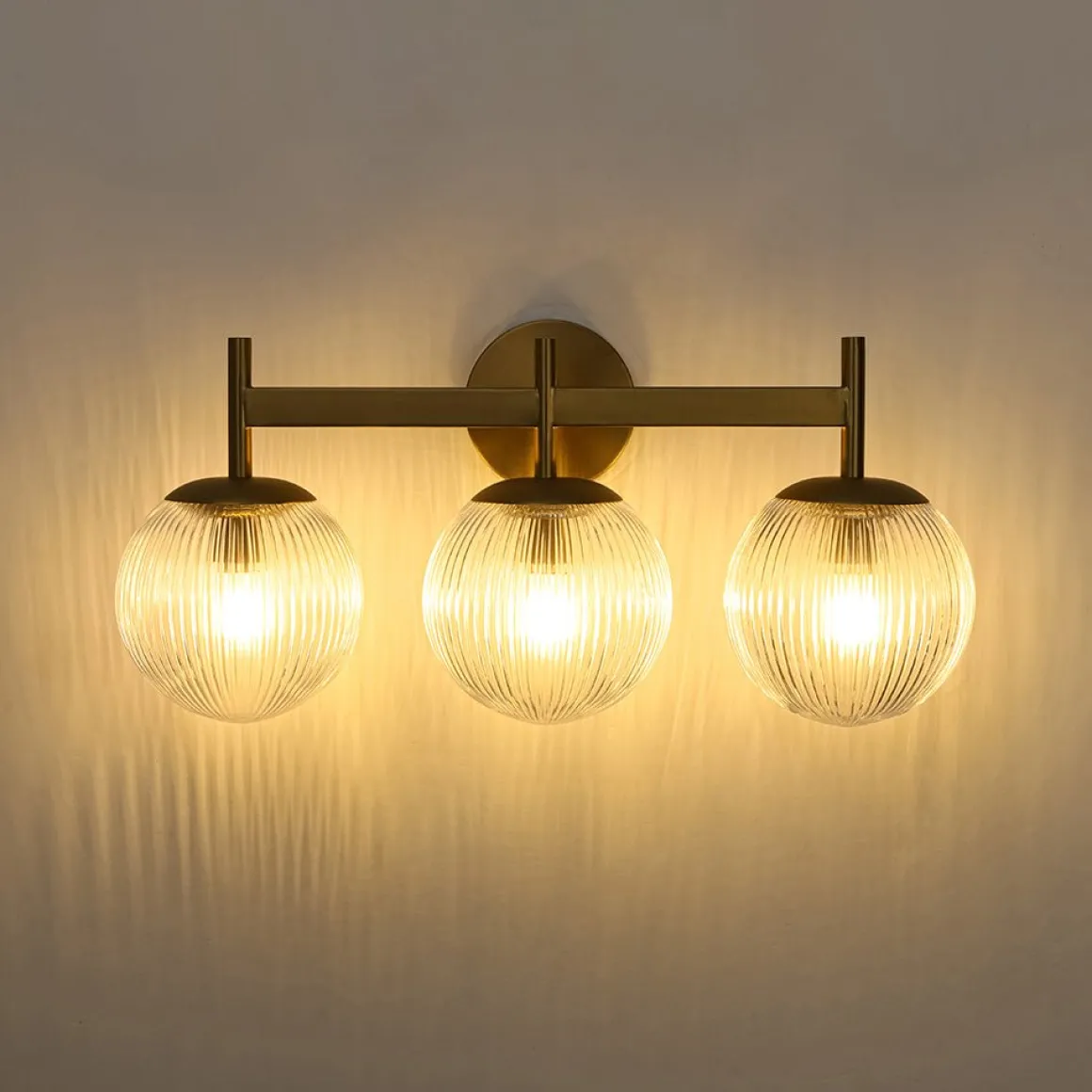 3-Light Brass Ribbed Glass Globe Vanity Wall Sconce